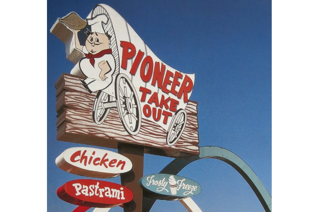 Pioneer Take Out roadside sign featuring a covered wagon, chef, and smaller Chicken and Pastrami signs.