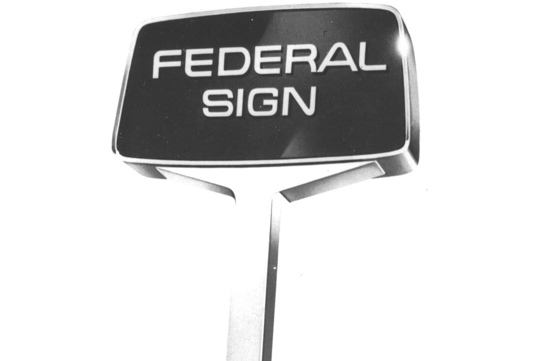 Black-and-white photograph of a Federal Sign pole sign.
