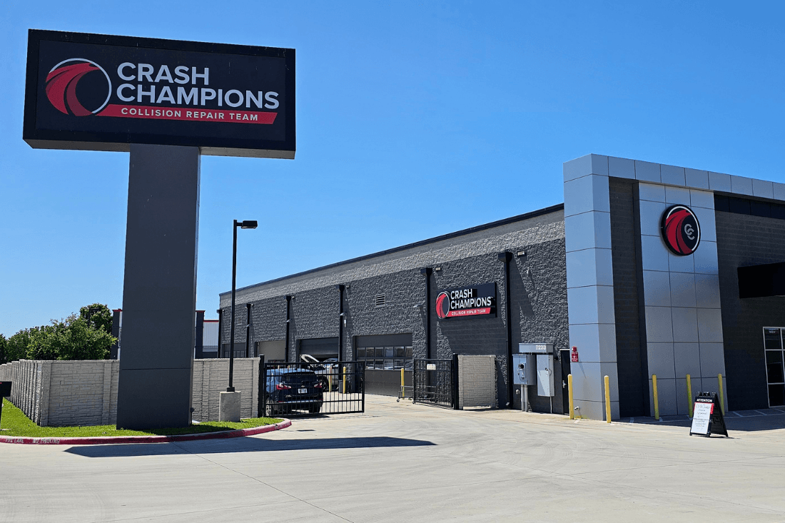 Crash Champions collision repair facility with matching pylon and building signs.