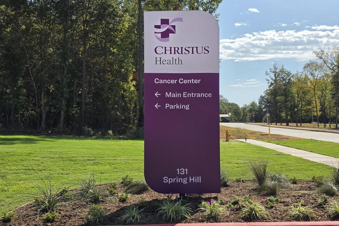 CHRISTUS Health Cancer Center directional sign pointing to the main entrance and parking.