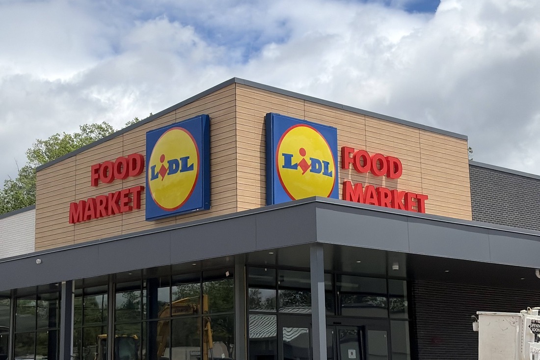 Lidl grocery store in Tappan, New York, with exterior logo signs and red “Food Market” channel letters on two sides of the building.