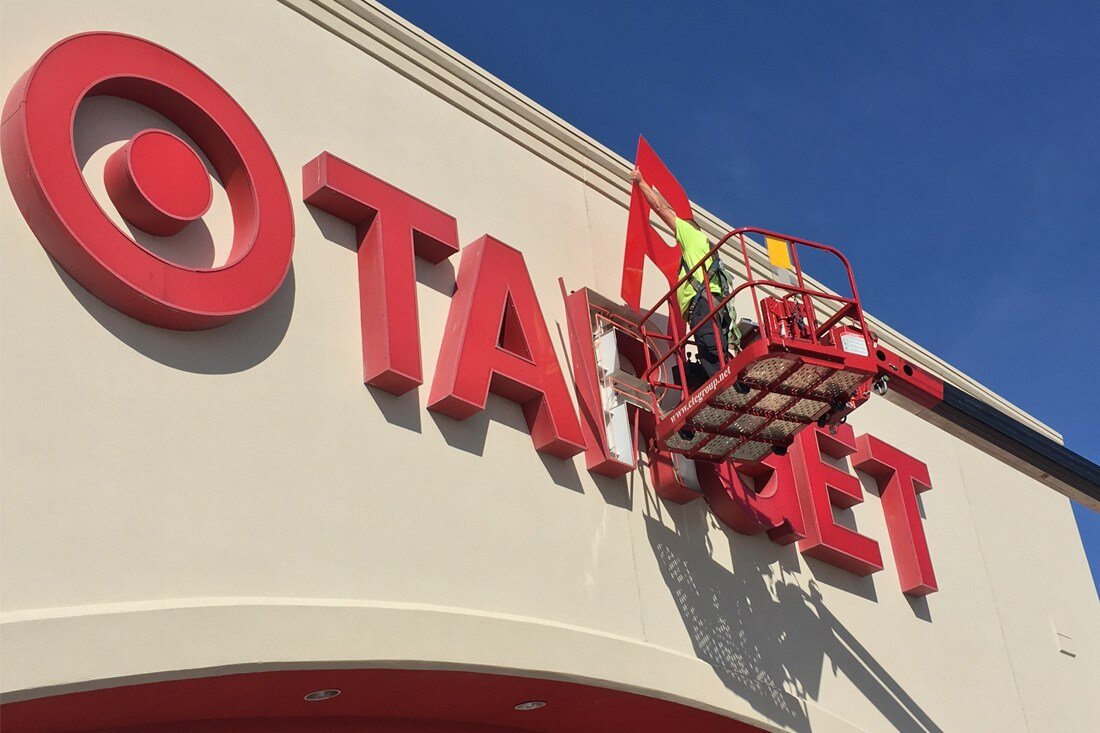 Man doing retrofit maintenance on target channel letters