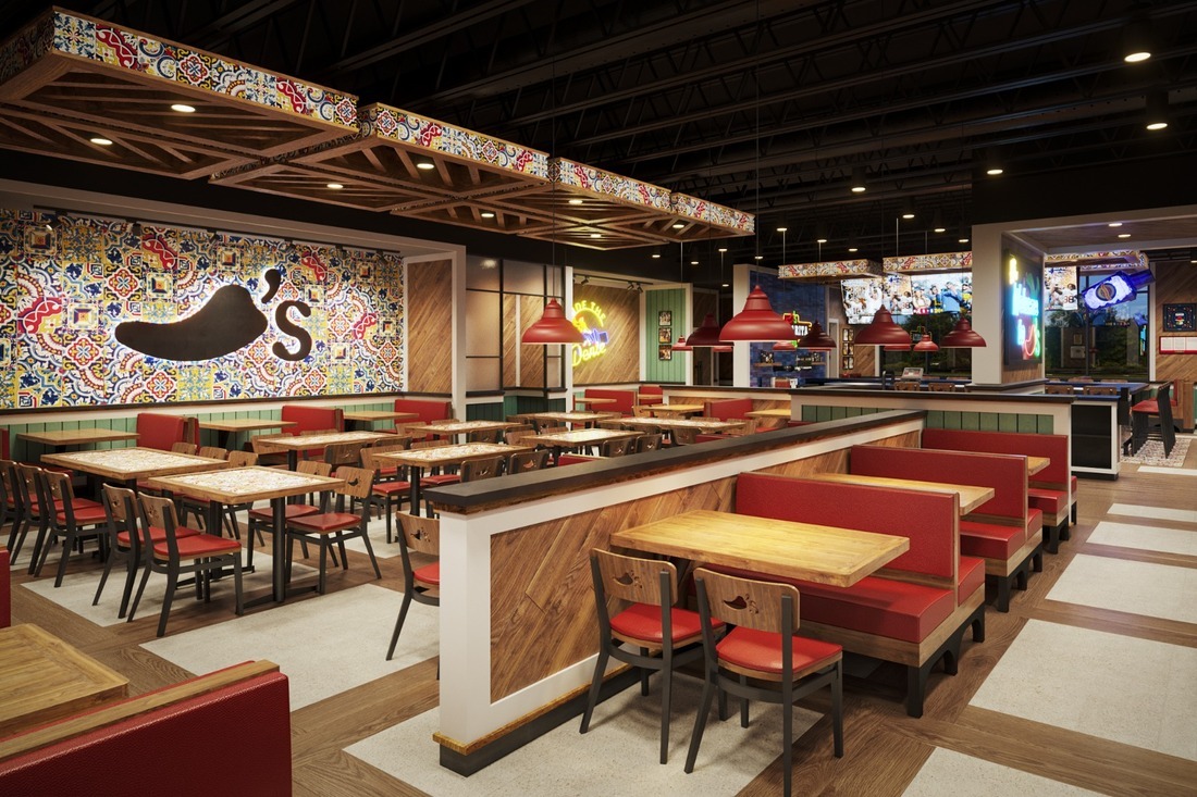 Chili’s restaurant interior rendering featuring a large chili pepper logo, colorful patterned wall graphics, illuminated signs, and red booth seating.