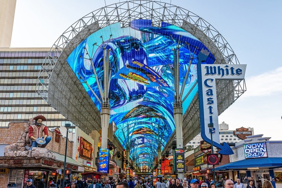 Fremont Street Experience LED canopy displaying colorful imagery above a busy Las Vegas pedestrian street.