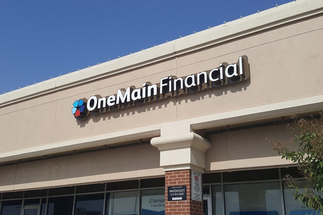 OneMain Financial dimensional lettering and multicolor logo above a branch storefront.