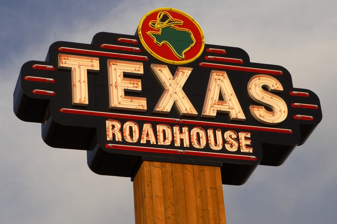 texas roadhouse neon open face channel letters on pylon sign